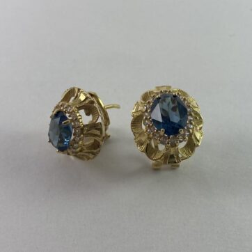 Aretes con diseño de flor y piedra azul